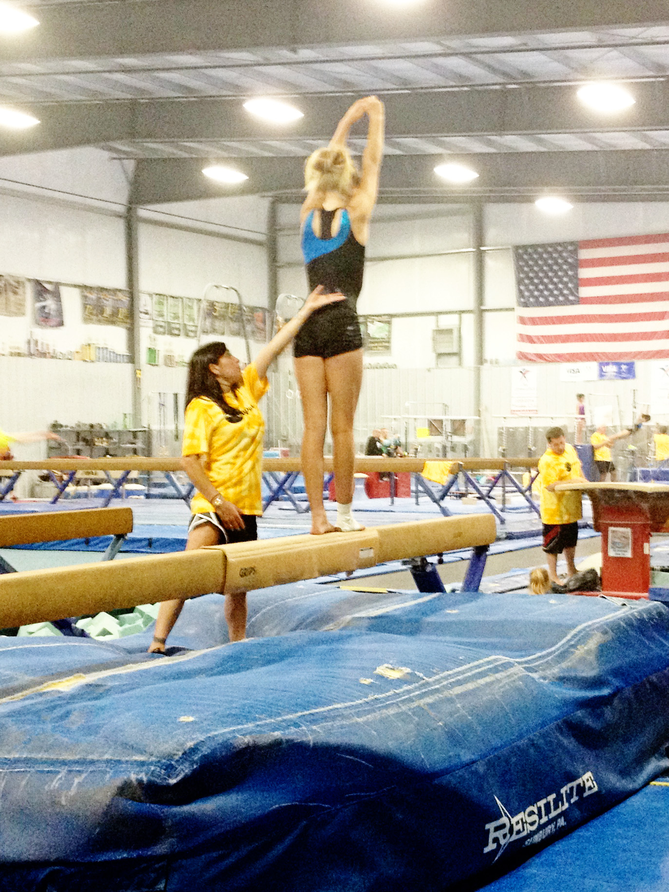 Oregon Olympic Athletics Coach Mohini teaching  beam as a guest coach at Dan Alch's camp of Champions.  