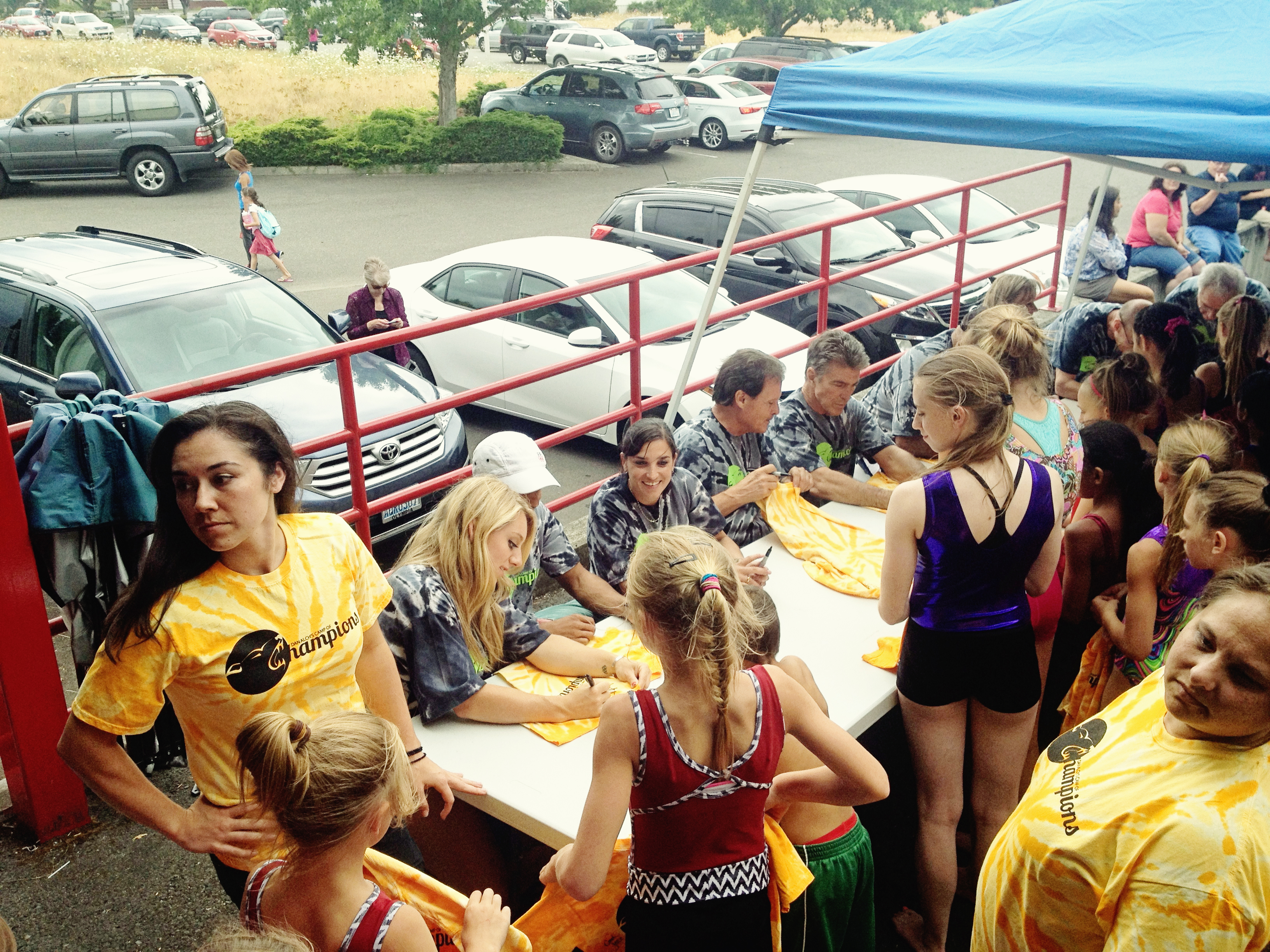 Coach Mohini (2004 Olympian) autographing shirts for the campers with Samantha Peszek (2008 Olympian) and Raj Bhavsar (2008 Olympian) at the Dan Alchs Camp o fChampions