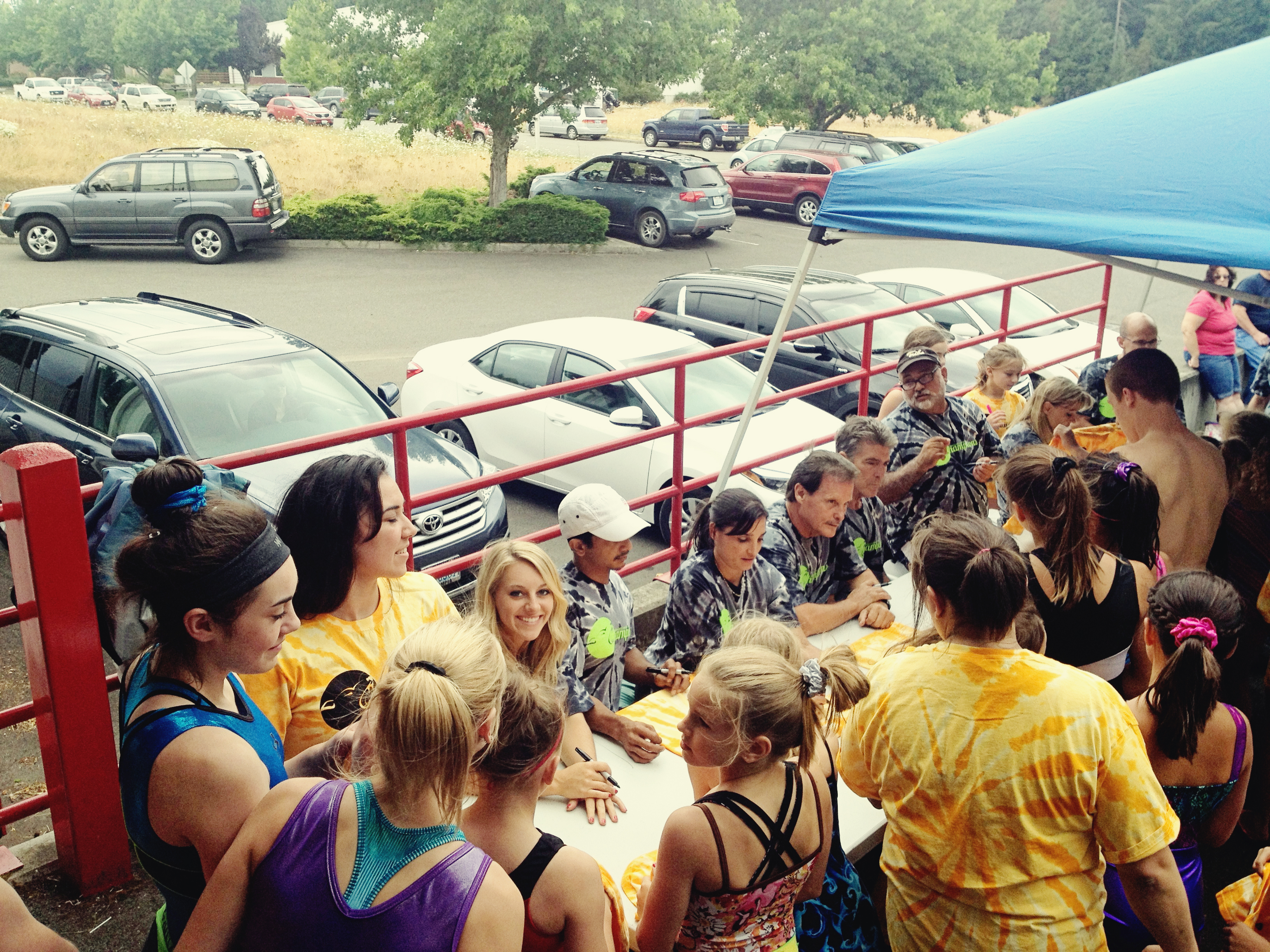 Coach Mohini (2004 Olympian) autographing shirts for the campers with Samantha Peszek (2008 Olympian) and Raj Bhavsar (2008 Olympian) at the Dan Alchs Camp o fChampions